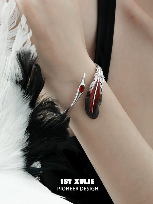 Elegant bloody feather bracelet by 1STXULIE featuring red and black accents on a silver band