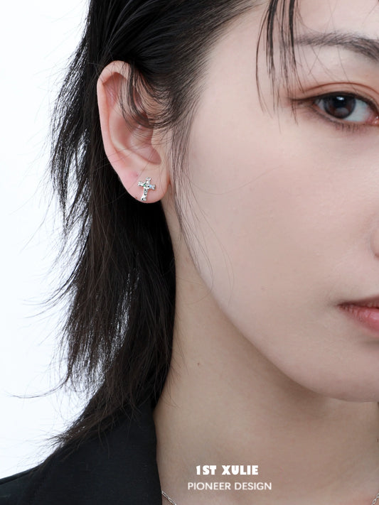 Elegant frozen cross zircon earrings displayed on a model's ear for a stylish look