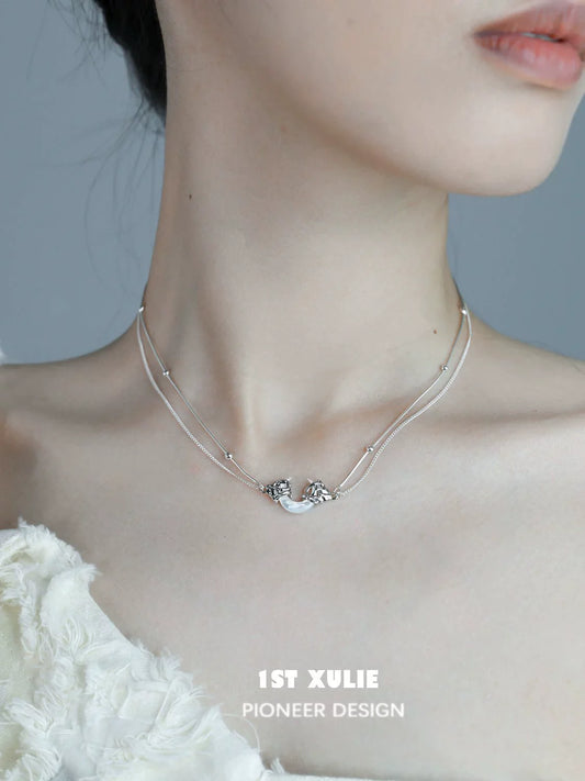 Moonlight couple necklace with elegant design, featuring intertwined silver strands and unique detailing