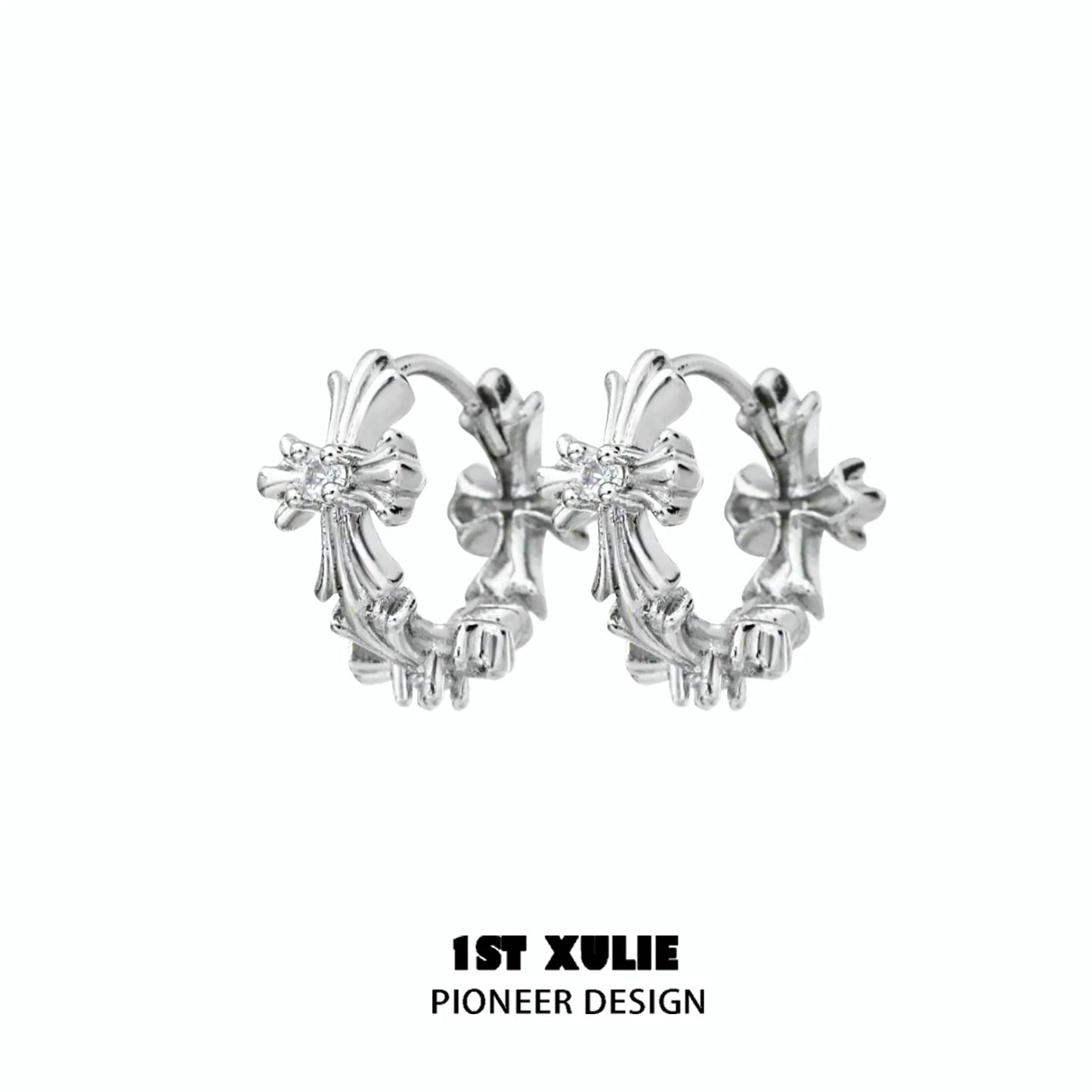 Elegant spiked cross earrings in silver with intricate design, perfect for a bold fashion statement
