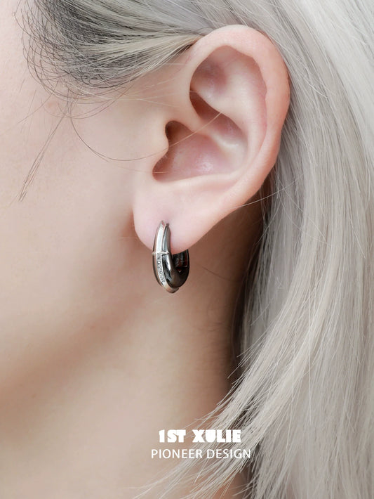 Stylish urban edge hoop earrings showcased on a model with light hair, perfect for modern fashion lovers.