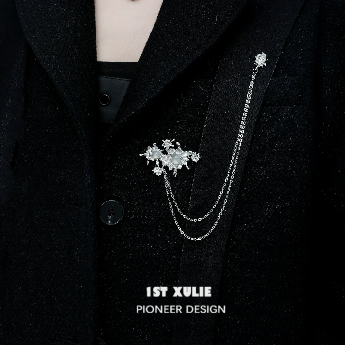Elegant silver chain brooch featuring white agate stones, perfect for adding style to jackets