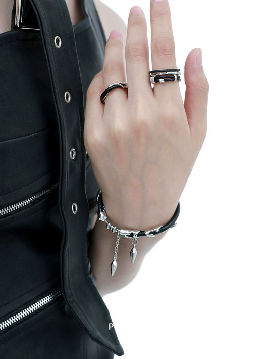 Y2K black chain leather bracelet with silver accents, styled elegantly on a model's wrist