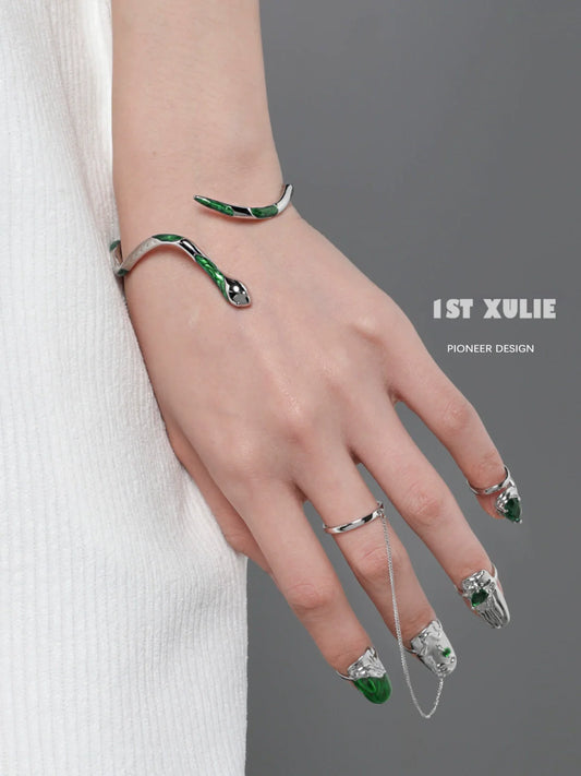 Y2K Slytherin snake bracelet featuring green accents and a sleek design on a model's wrist