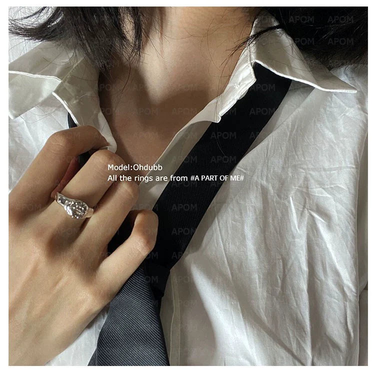Elegant self-love ring for women, showcasing intricate design worn on a hand with a collar and tie