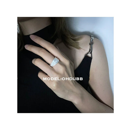Stylish silver bandage ring worn on a model's hand showcasing its elegant design