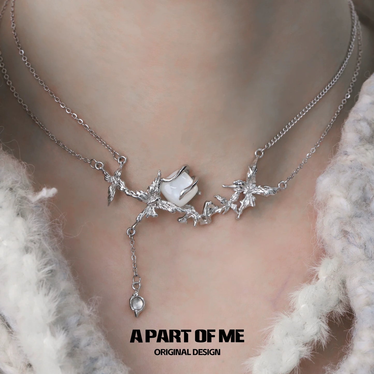 A PART OF ME white butterfly shell necklace featuring intricate silver design and delicate charms
