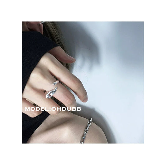 Y2K silver statement ring worn on a hand with a trendy outfit for a modern look