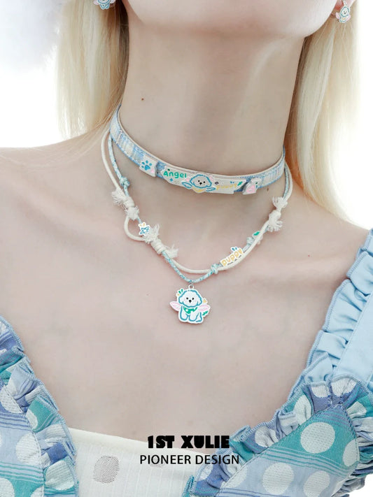 Trendy angel cat and puppy necklace layered with colorful accents for a whimsical look
