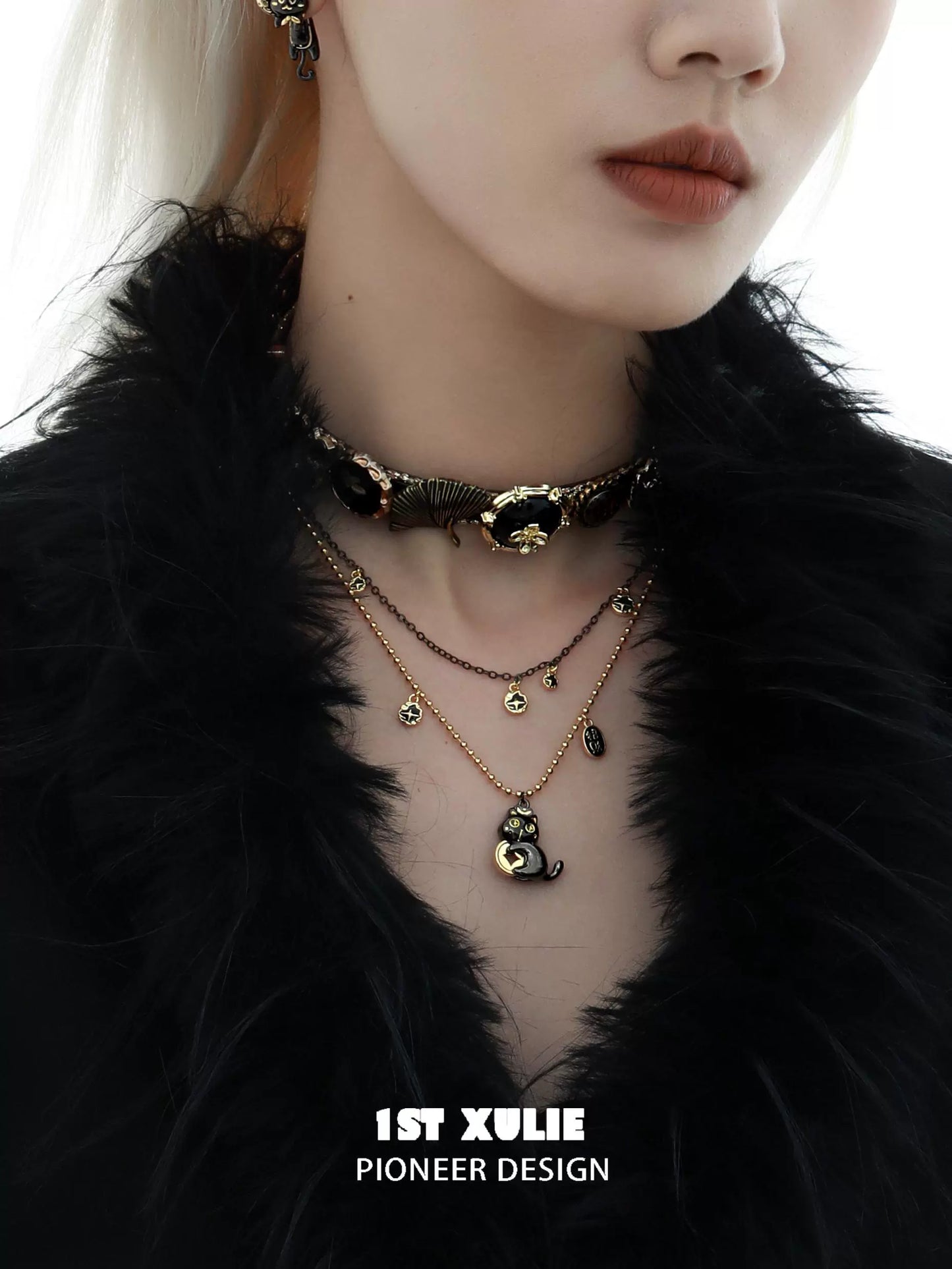 Black gold cat necklace with layered design, featuring a charming cat pendant and elegant chain styling