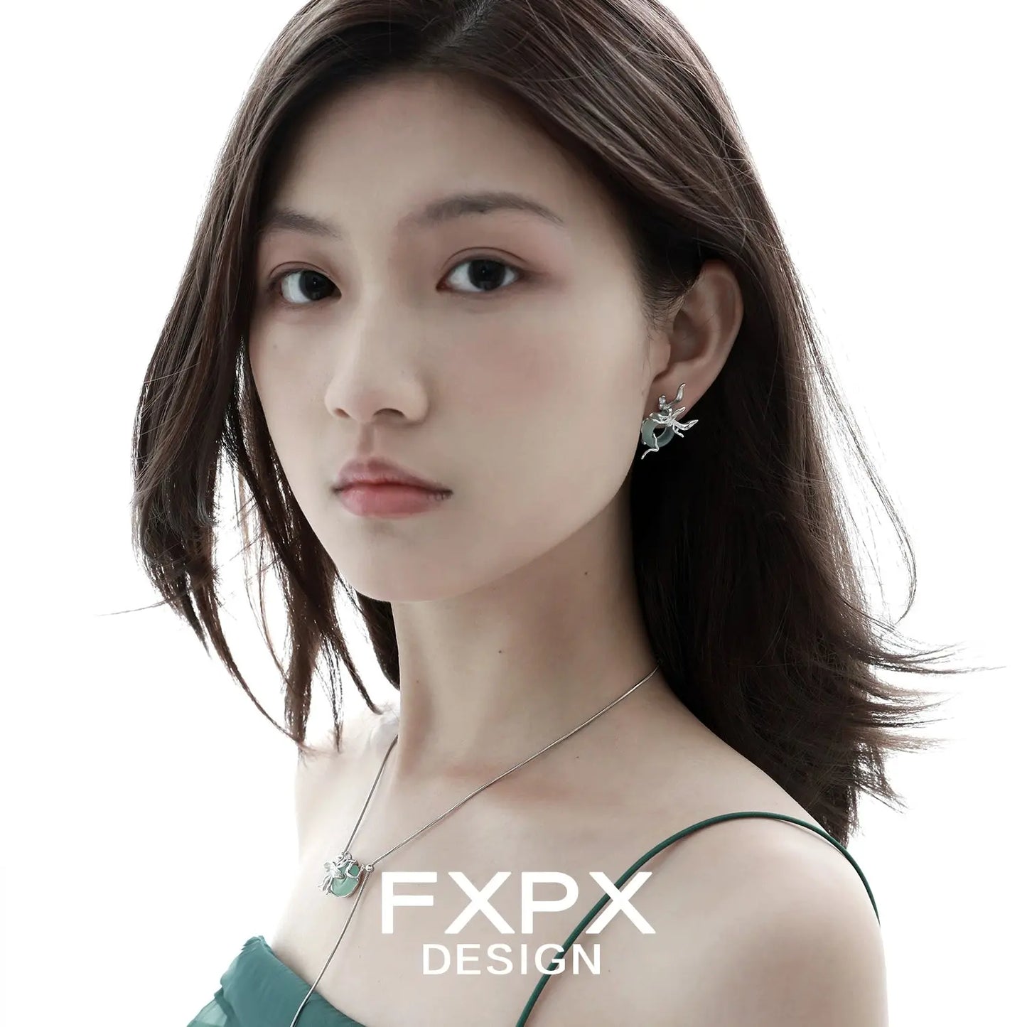 Woman wearing unique jade earrings for women by FXPX with matching necklace and green dress