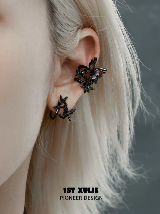 Dark thorn butterfly earrings in black metal design worn on an ear for a unique fashion statement