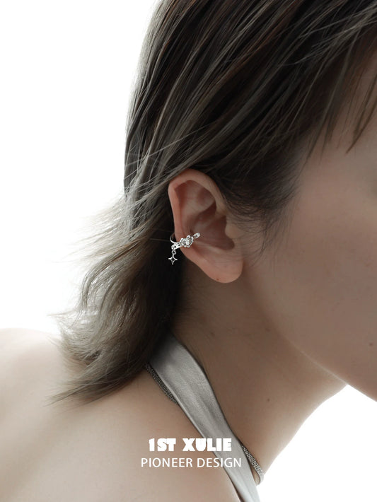 Edgy heart ear cuff in silver worn on a model's ear for a stylish accessory look