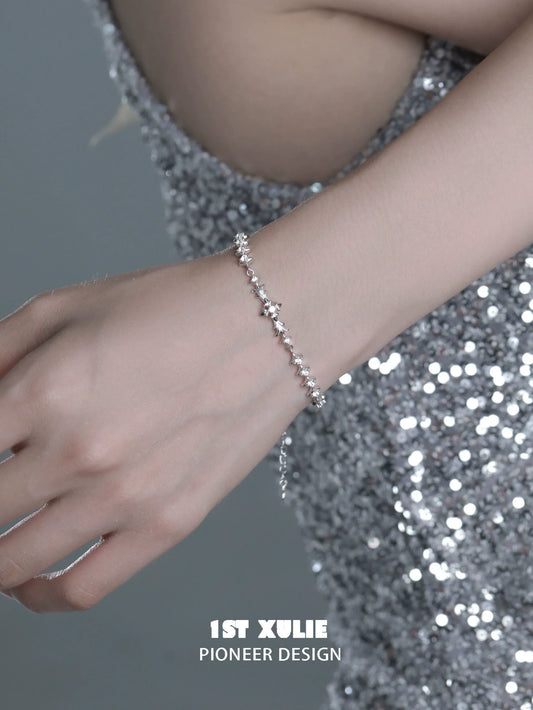 Elegant four-point star silver bracelet showcased on a hand, perfect for stylish occasions
