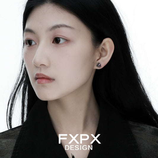 Woman wearing bloody doll jewelry amethyst dragon earrings with triangular purple stones