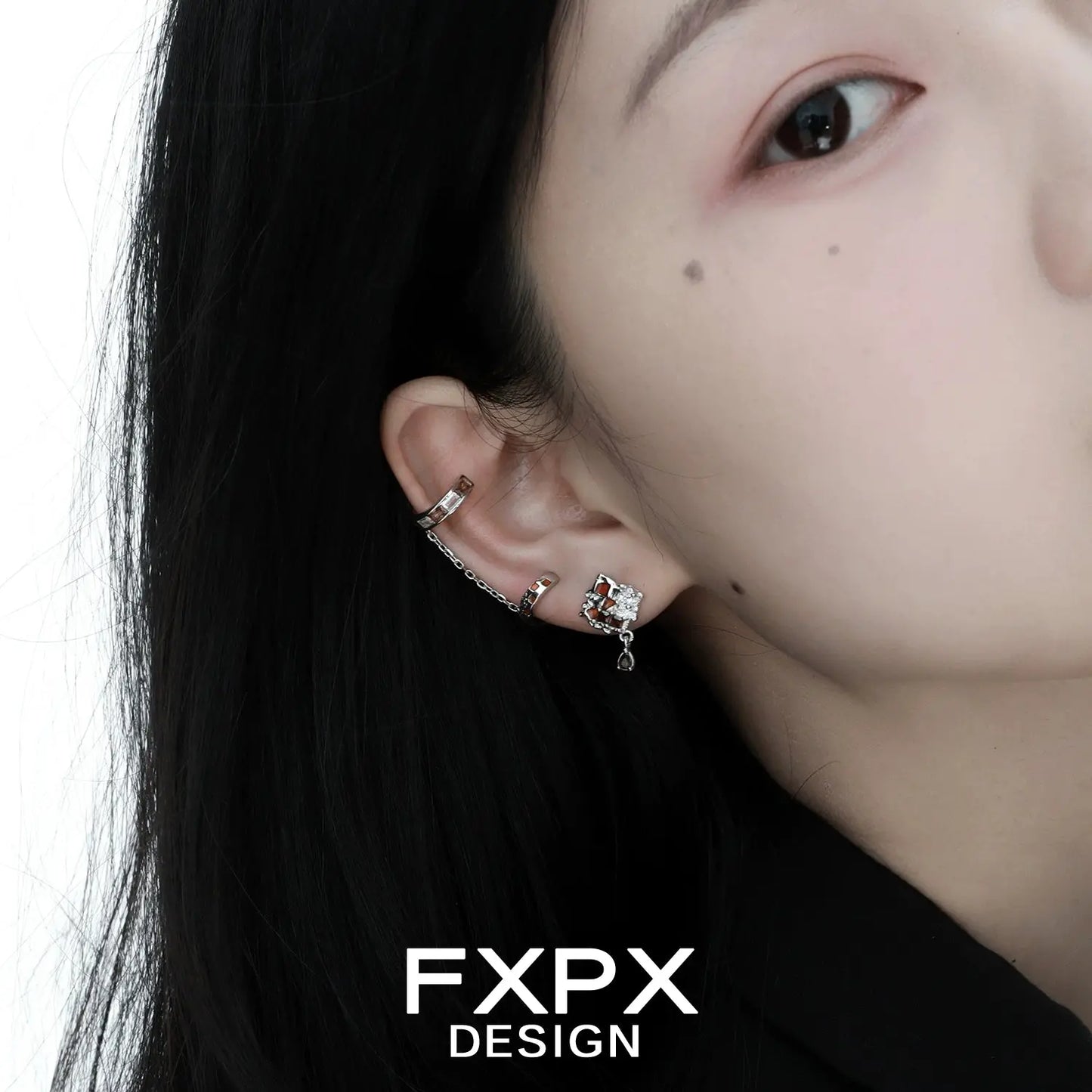 Bloody doll jewelry checkerboard ear cuff on model with multiple silver ear piercings