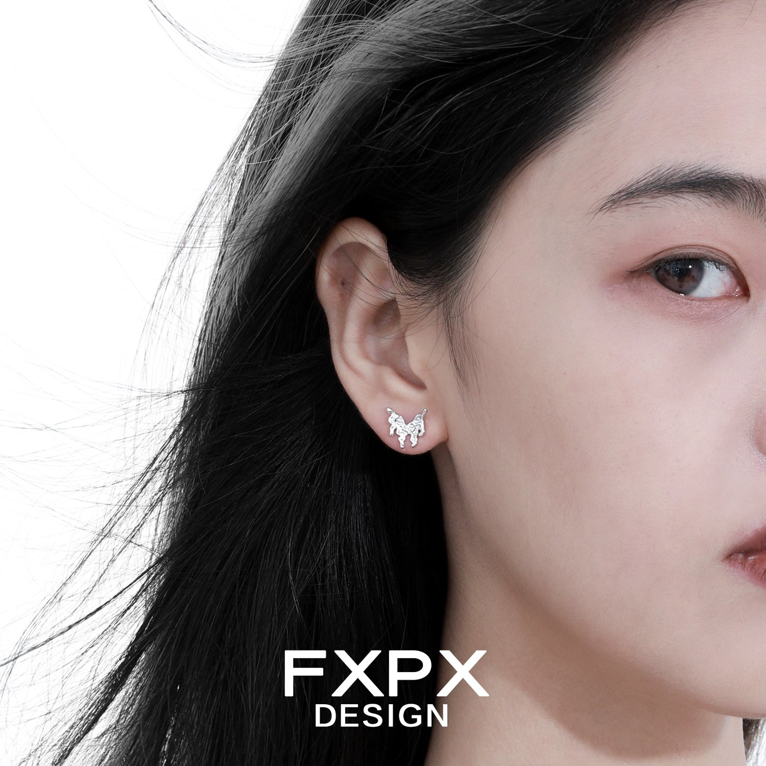 Close-up of woman wearing Bloody Doll Jewelry cyber butterfly earrings in silver by FXPX