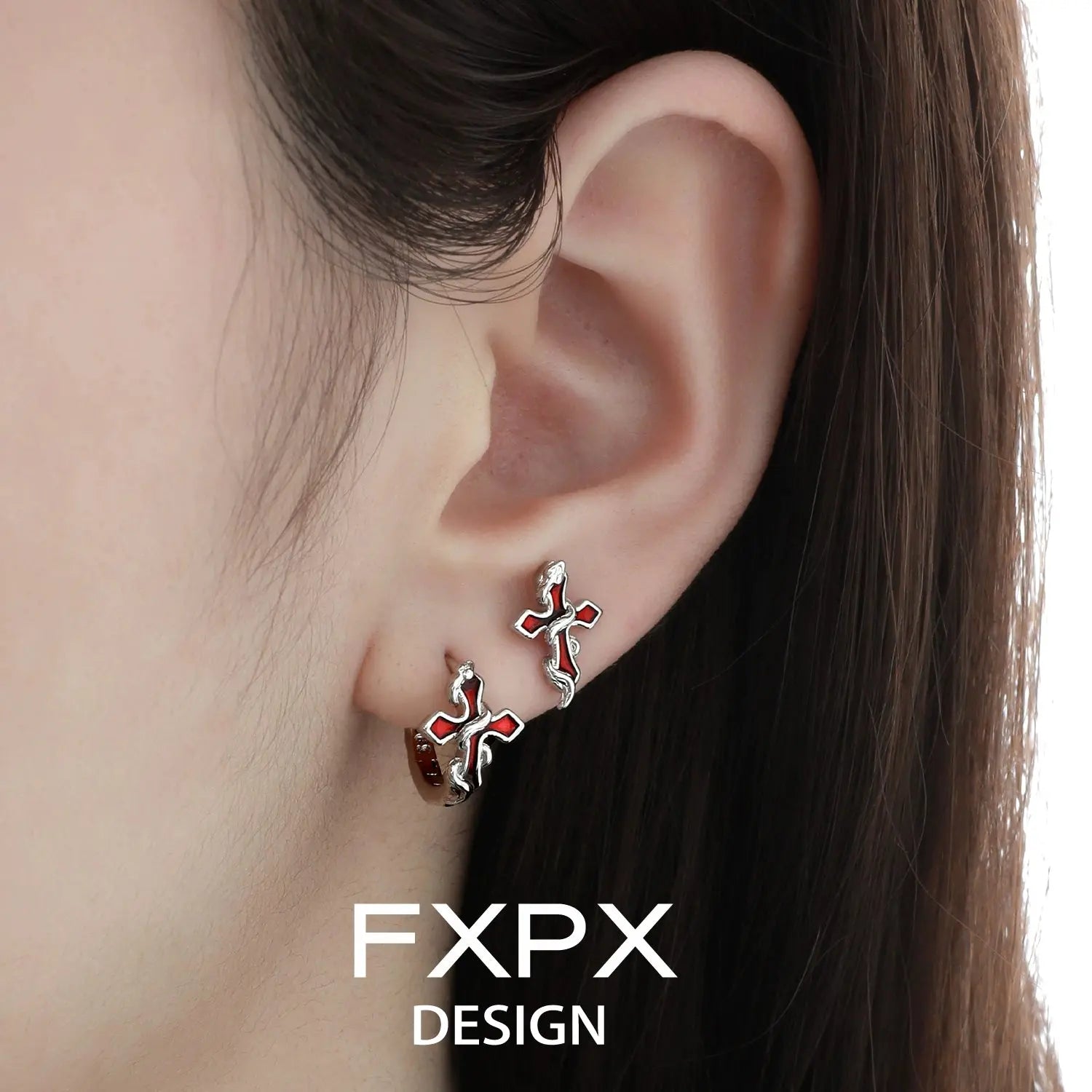 Close-up of bloody doll jewelry gothic cross snake earrings worn on ear by FXPX
