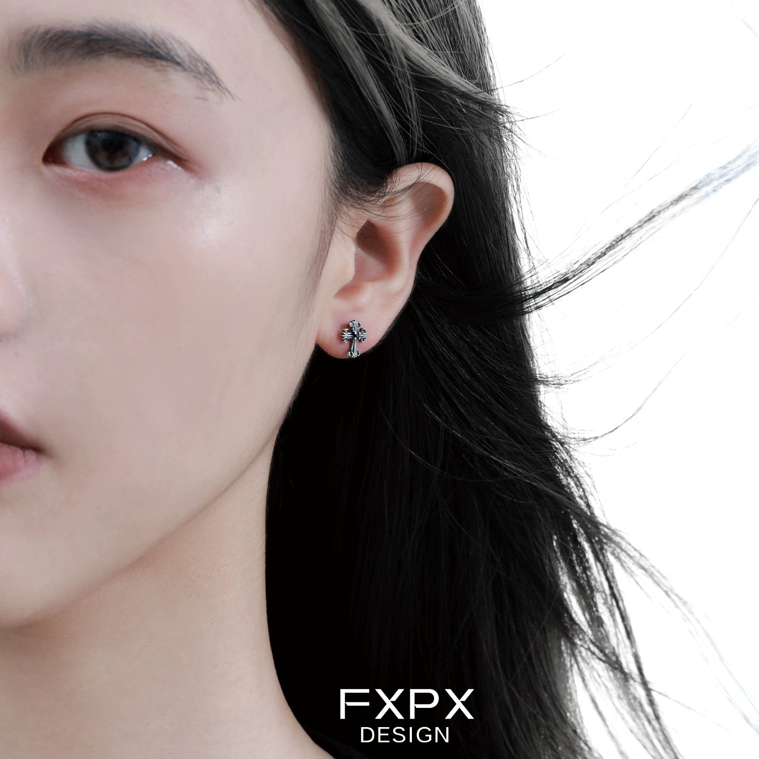 Close-up of a woman wearing bloody doll jewelry gothic cross stud earrings by FXPX