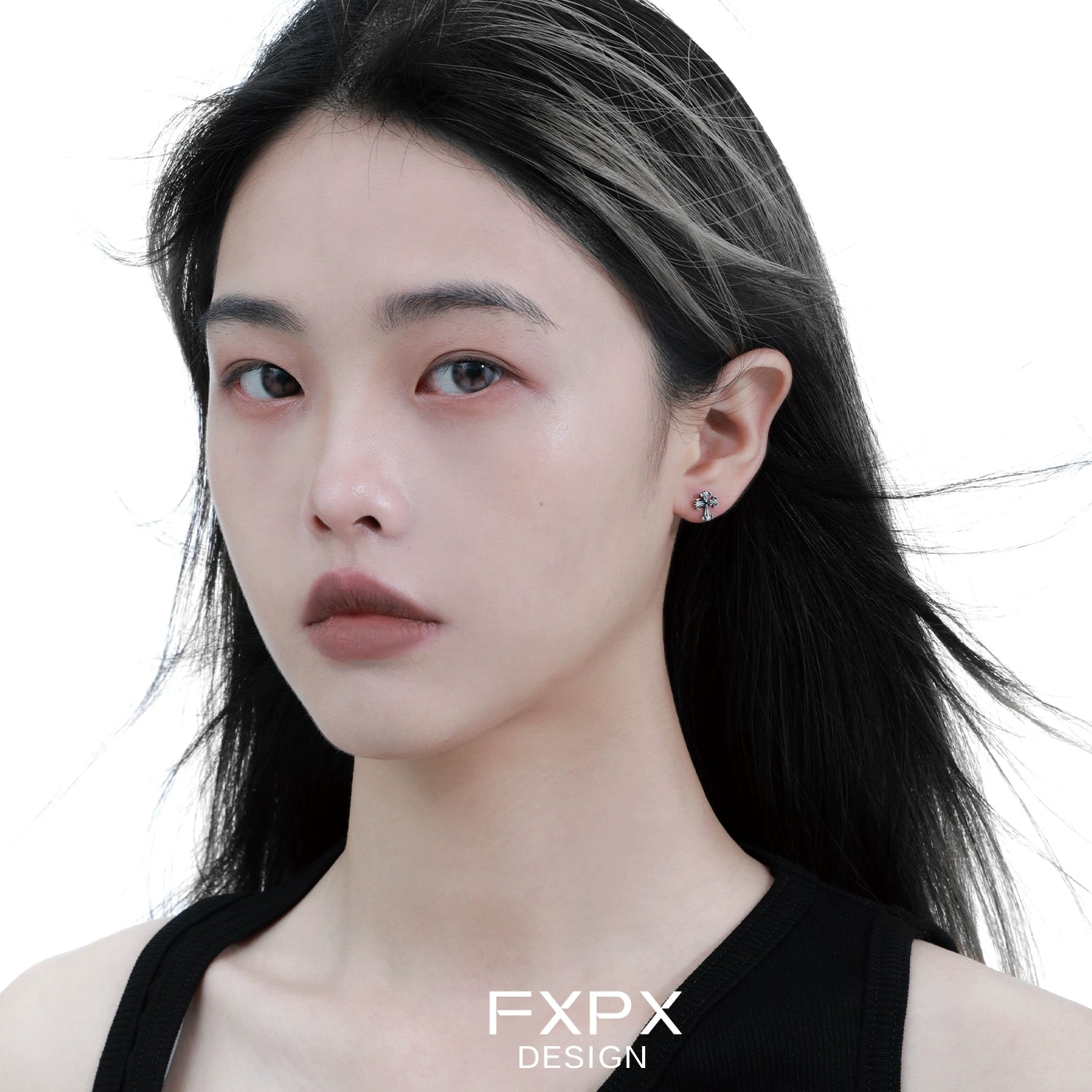 Model wearing bloody doll jewelry gothic cross stud earrings from FXPX with black hair and neutral makeup