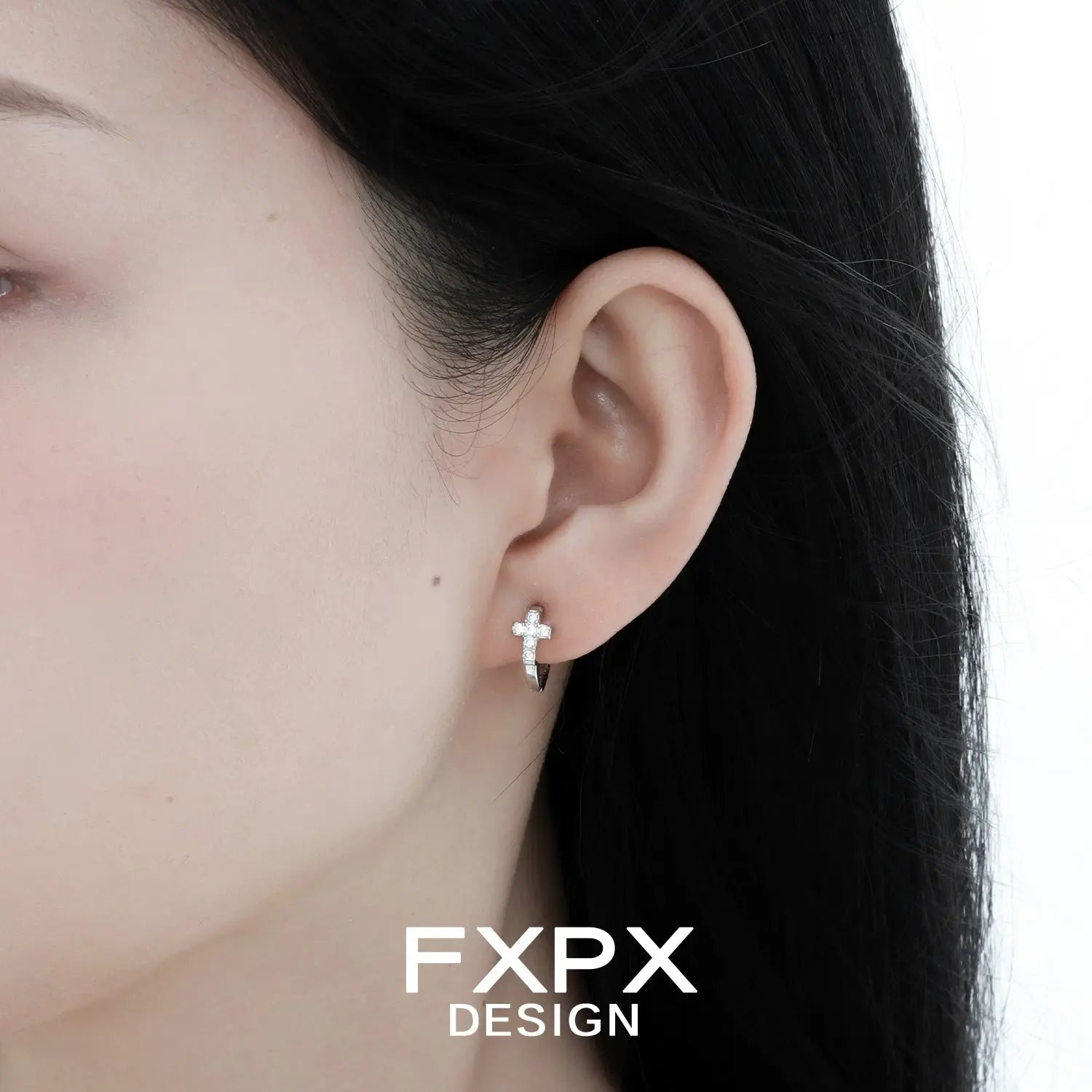 Model wearing bloody doll jewelry gothic cross stud earrings in silver with clear stones