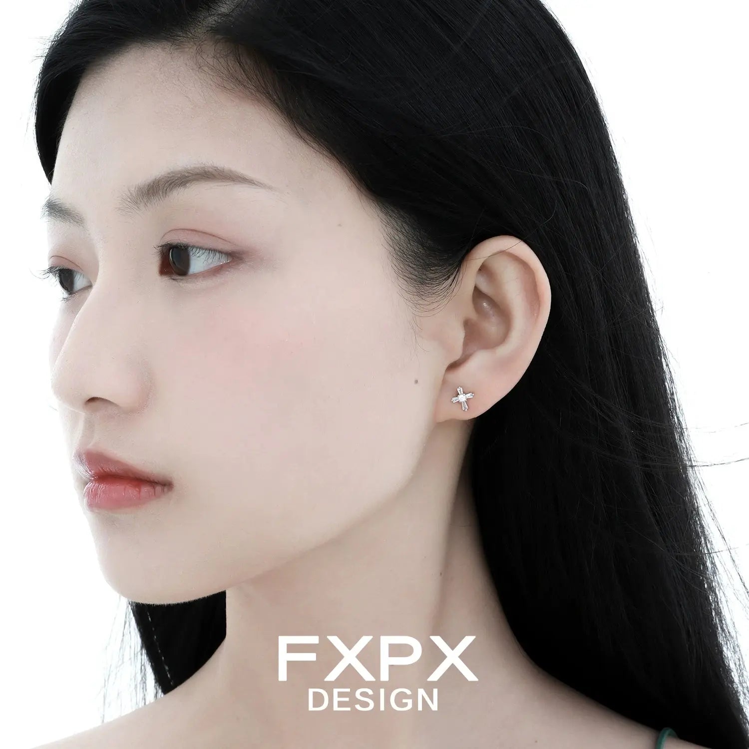 Woman wearing bloody doll jewelry gothic cross stud earrings with minimalistic design by FXPX