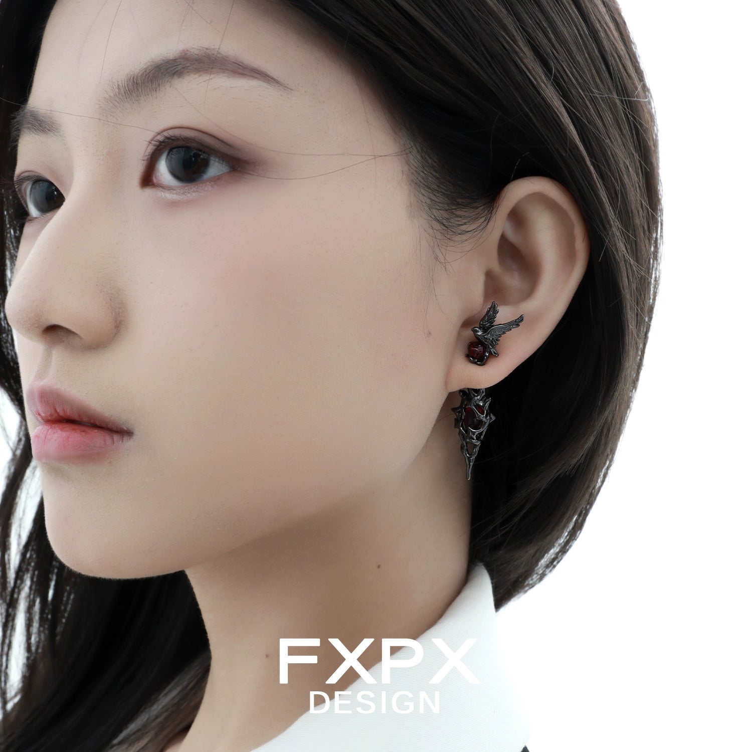 Woman wearing Bloody Doll Jewelry gothic raven earrings by FXPX in dark metal design
