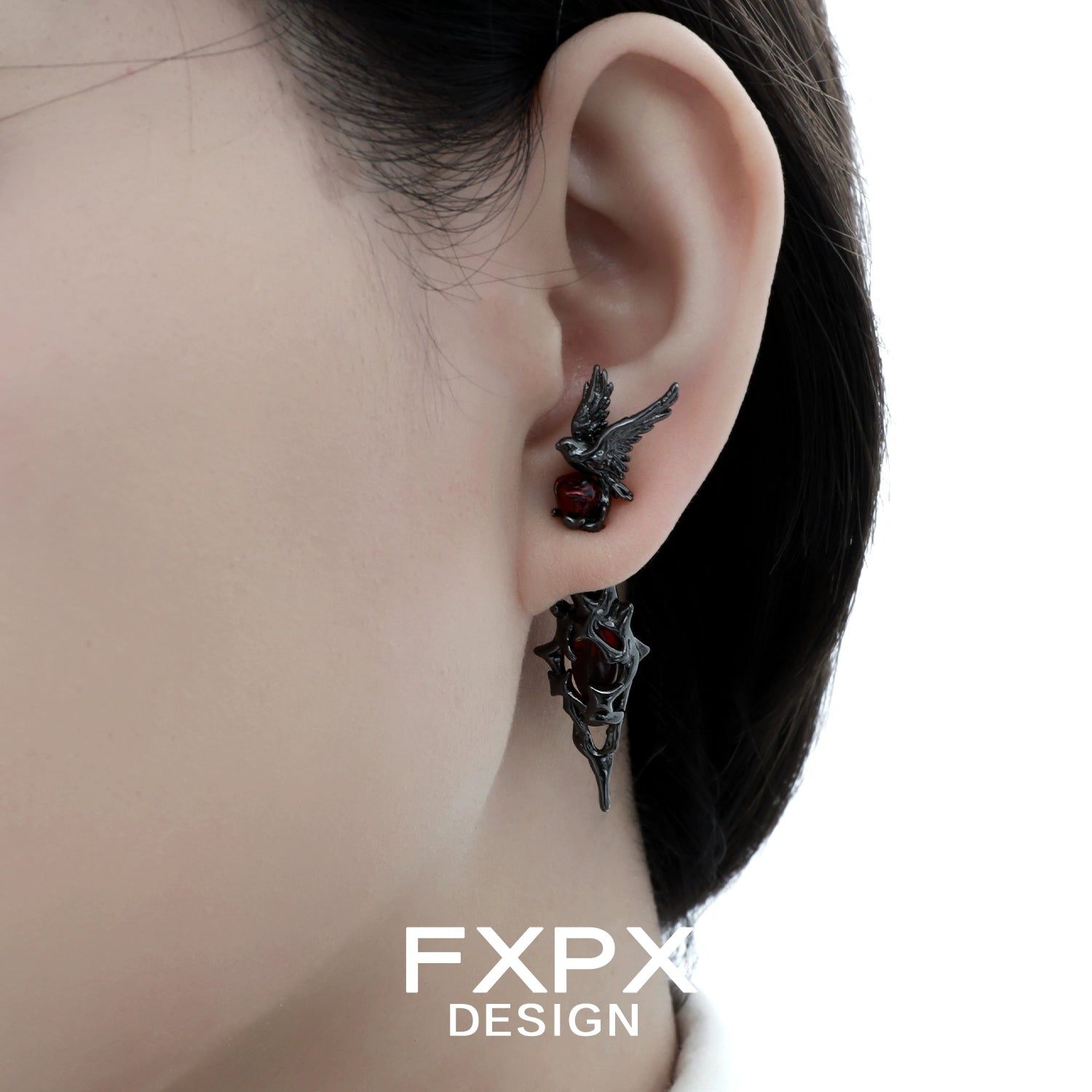 Bloody Doll Jewelry gothic raven earrings worn on ear featuring black raven and red accents