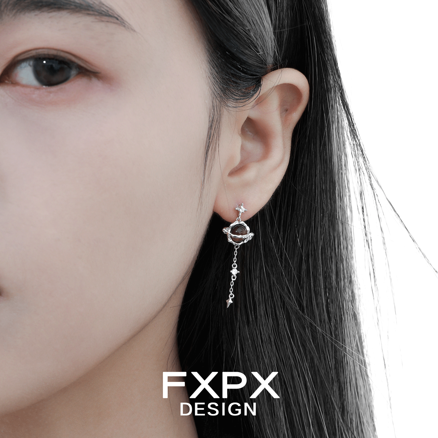 Bloody Doll Jewelry Gothic Saturn tiger eye earrings worn on a woman ear with silver chain detail