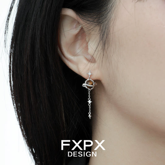 Bloody Doll Jewelry Gothic Saturn tiger eye earrings worn on ear with silver chain and star details