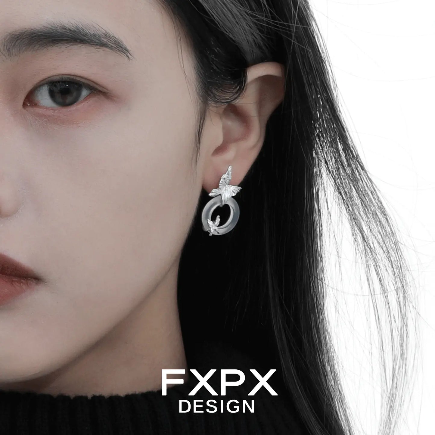 FXPX bloody doll jewelry modern butterfly hoop earrings worn on model's left ear in silver tone