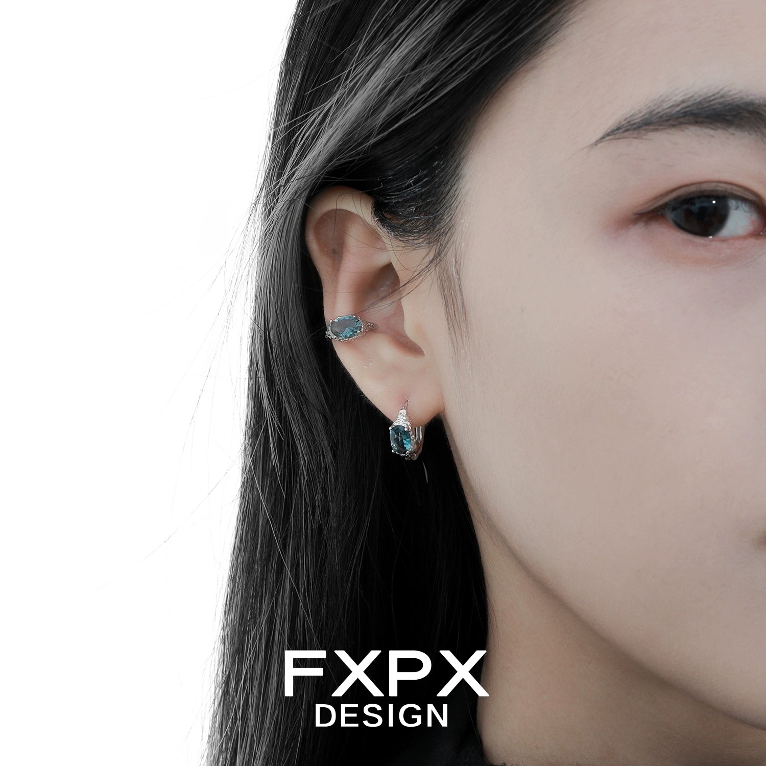 Bloody Doll Jewelry mystic iceland ear cuffs worn on a woman's ear with blue stones and silver design