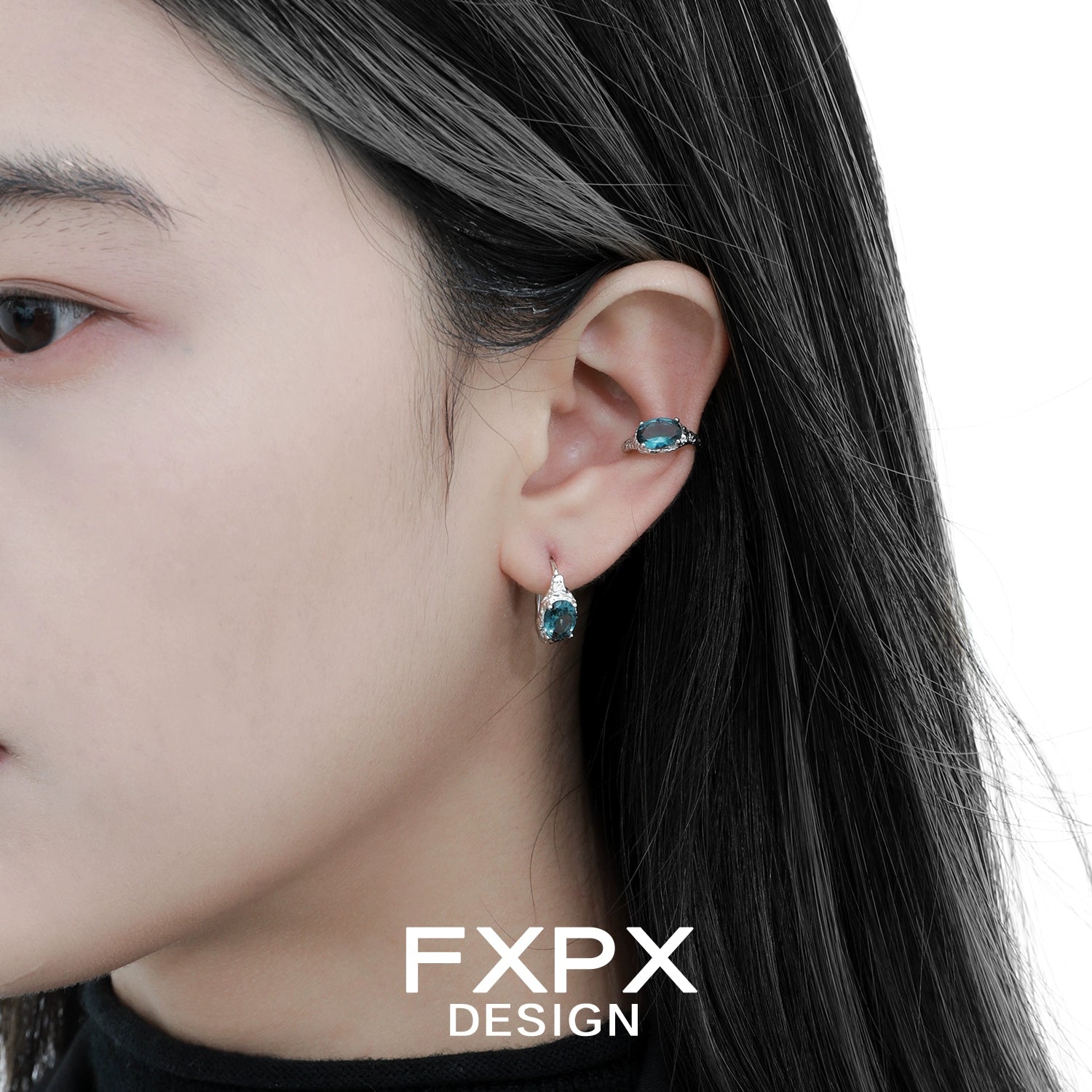 Bloody Doll Jewelry mystic iceland ear cuffs worn on a woman's ear with matching blue gemstone earrings