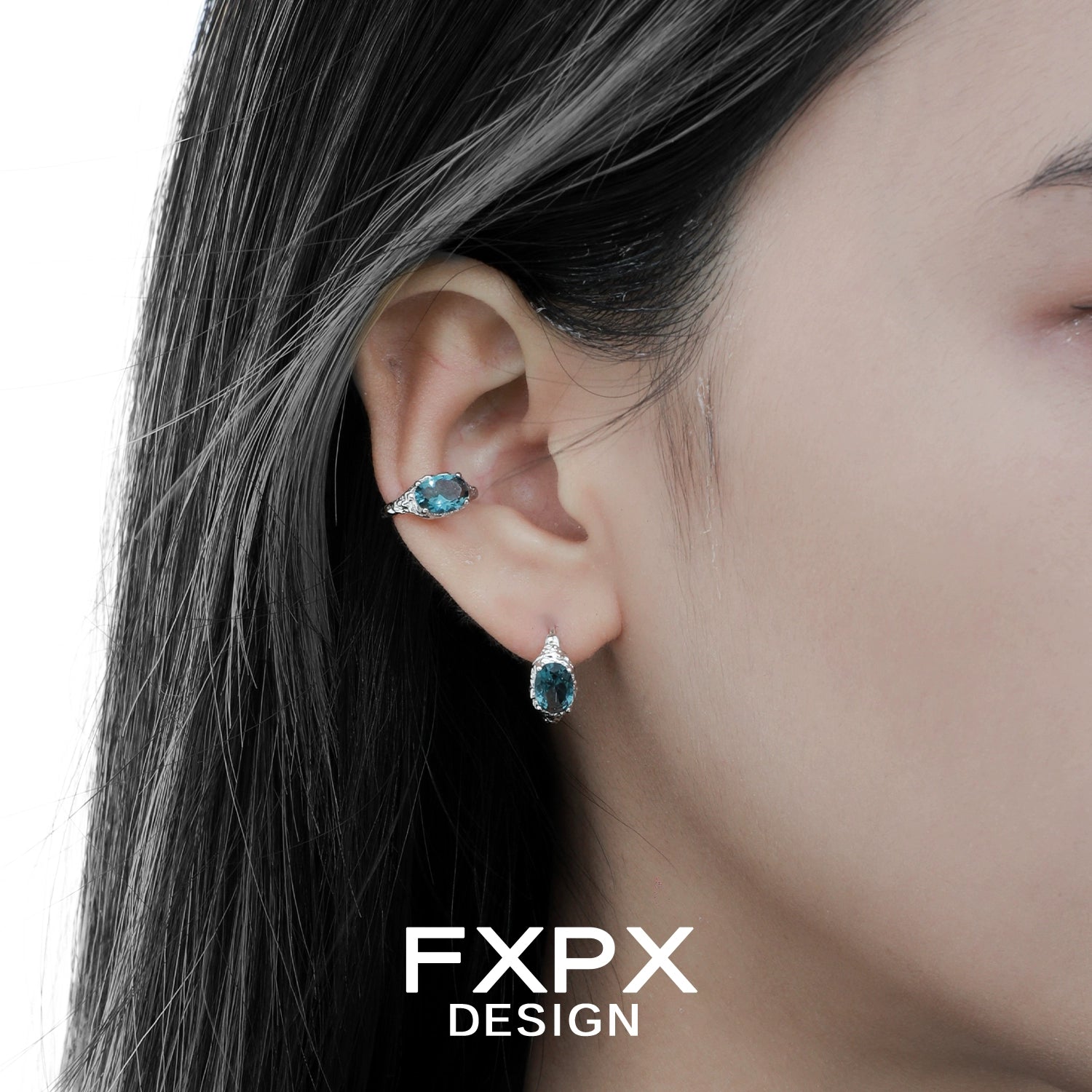 Close-up of model wearing Bloody Doll Jewelry mystic iceland ear cuffs with blue gemstones by FXPX