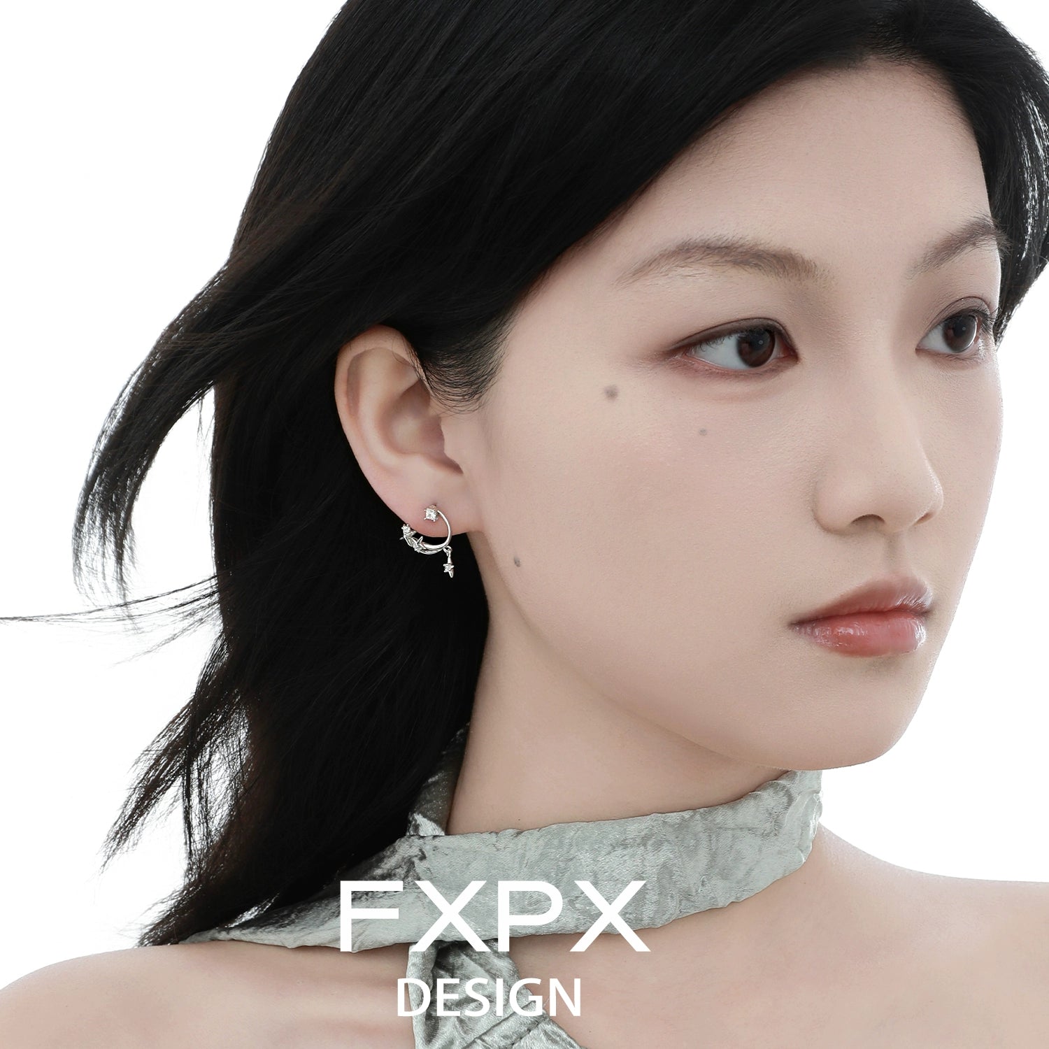 Woman wearing bloody doll jewelry silver star constellation stud earrings with delicate silver design