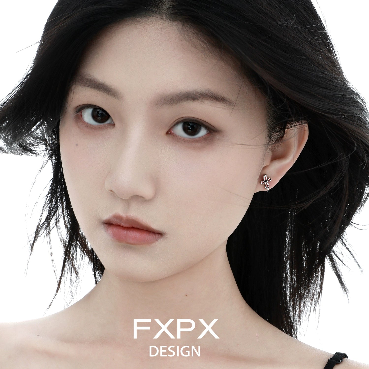 Woman wearing bloody doll Y2K snake cross earrings by FXPX with minimalist design