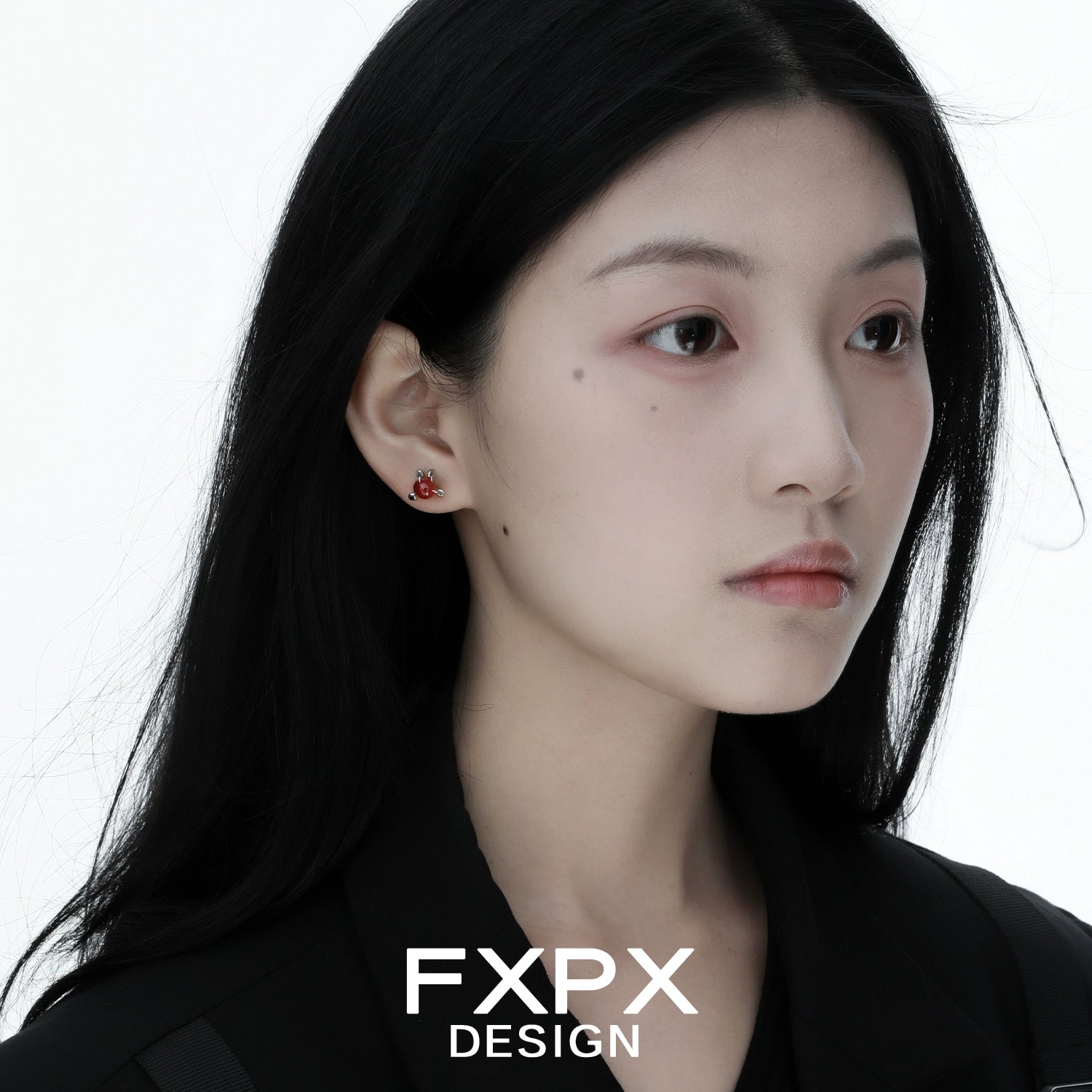Woman wearing bloody dragon claw gothic earrings by FXPX with black hair and dark outfit