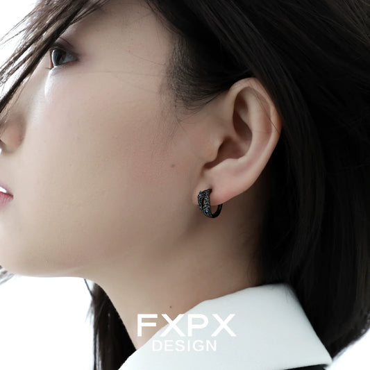 Elegant blue black rose stud earrings worn by a model with long hair for a chic look