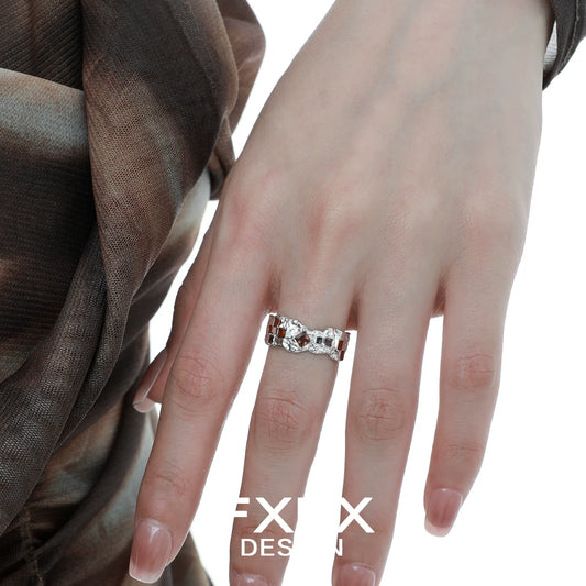 Stylish FXPX brown checkerboard silver ring showcased on a model's hand with elegant attire