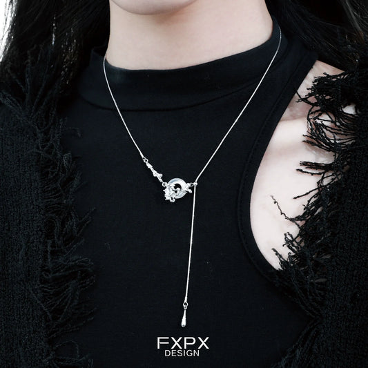 Elegant celestial eclipse agate necklace displayed on a model's neck, featuring a unique design and silver accents