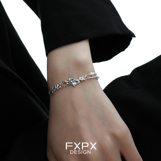 Elegant FXPX frost blue zircon bracelet featuring intricate floral design and a polished silver finish