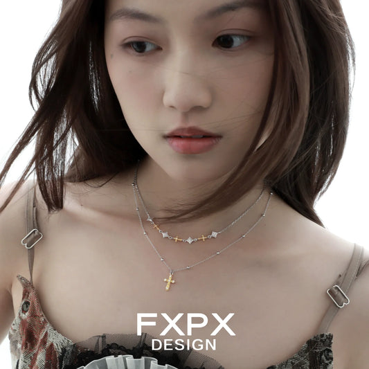 Elegant gold faith cross necklace paired with layered silver necklaces for a stylish look