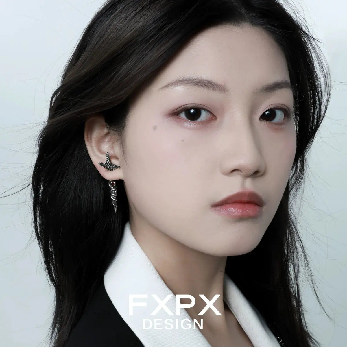 Woman wearing gothic rose red zircon earrings from FXPX with intricate dark floral design