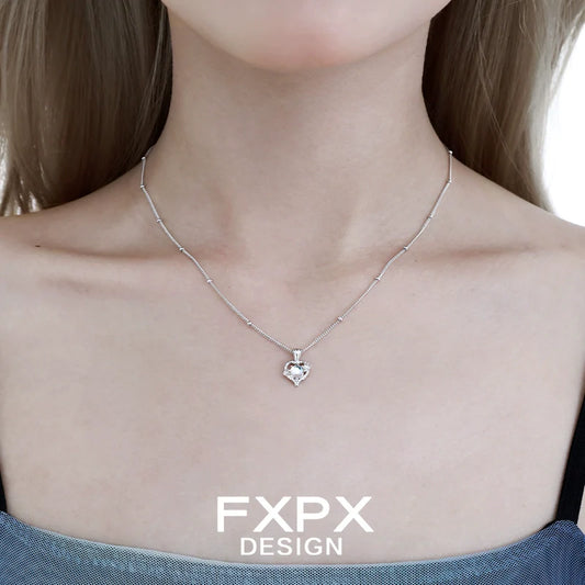 FXPX moonstone heart pendant necklace on a delicate silver chain, perfect for elegant outfits