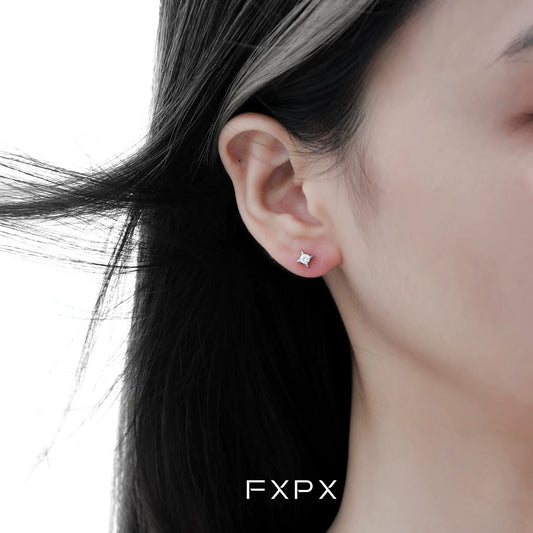 Radiant star silver stud earrings showcased on a model's ear for a sparkling look