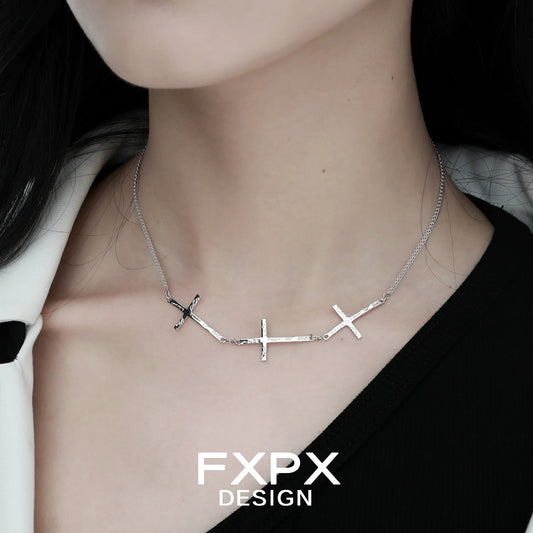 Elegant FXPX silver cross necklace featuring multiple polished crosses on a delicate chain