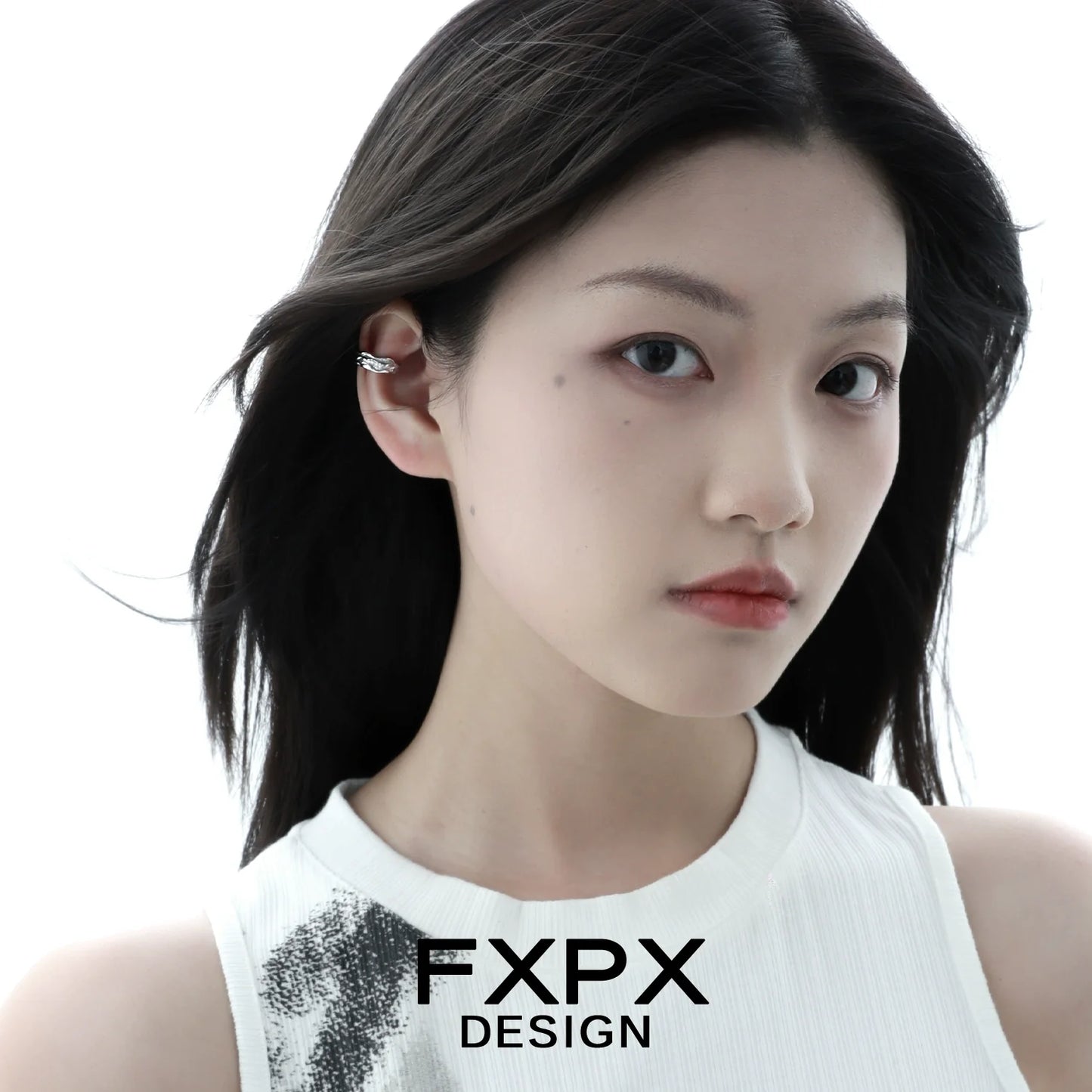 Model wearing an FXPX textured silver ear cuff for a stylish and modern look