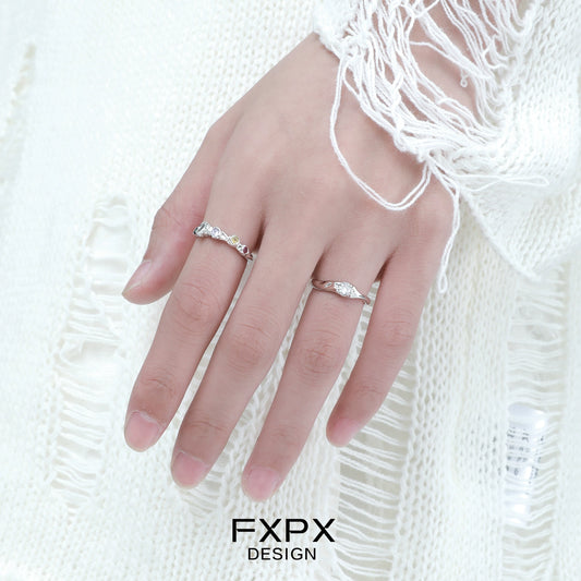 Stylish FXPX white zircon ring on a model's hand with a cozy sweater background