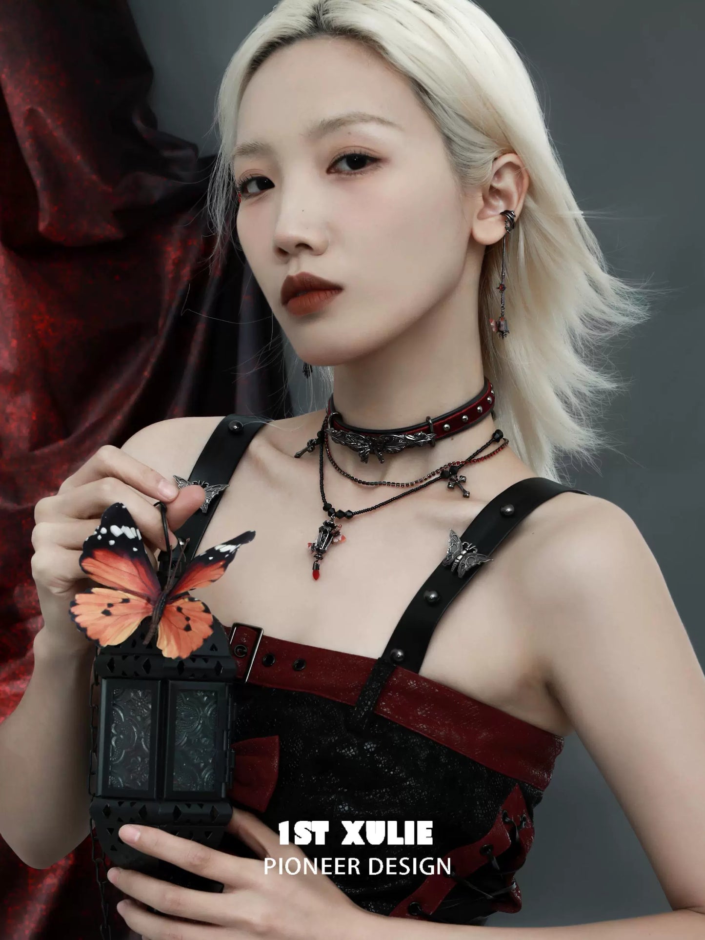 Model wearing gothic butterfly earrings with an elegant gothic outfit and accessories