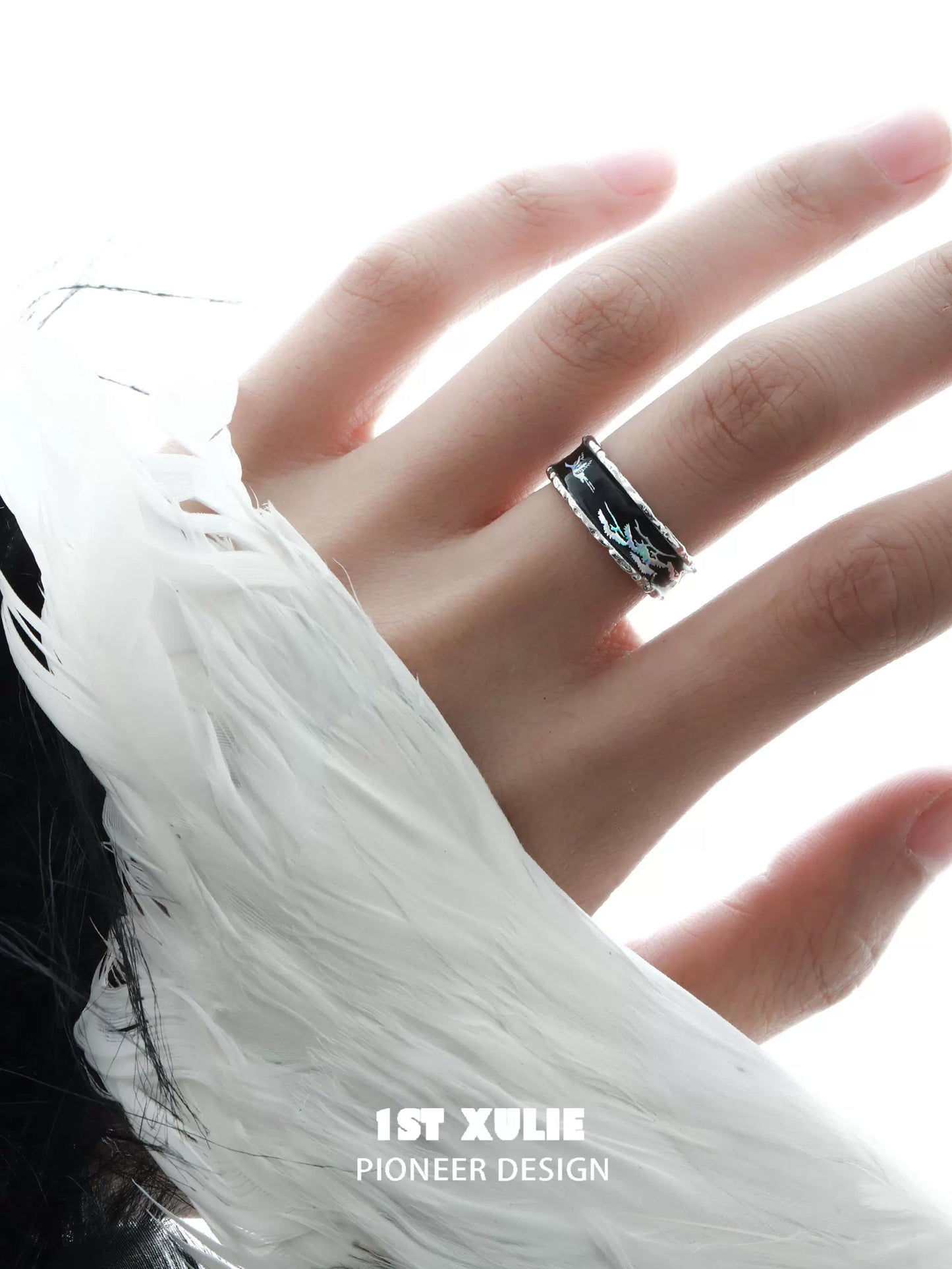 Stylish gothic crane silver ring worn on a hand with a feathered sleeve for a trendy look